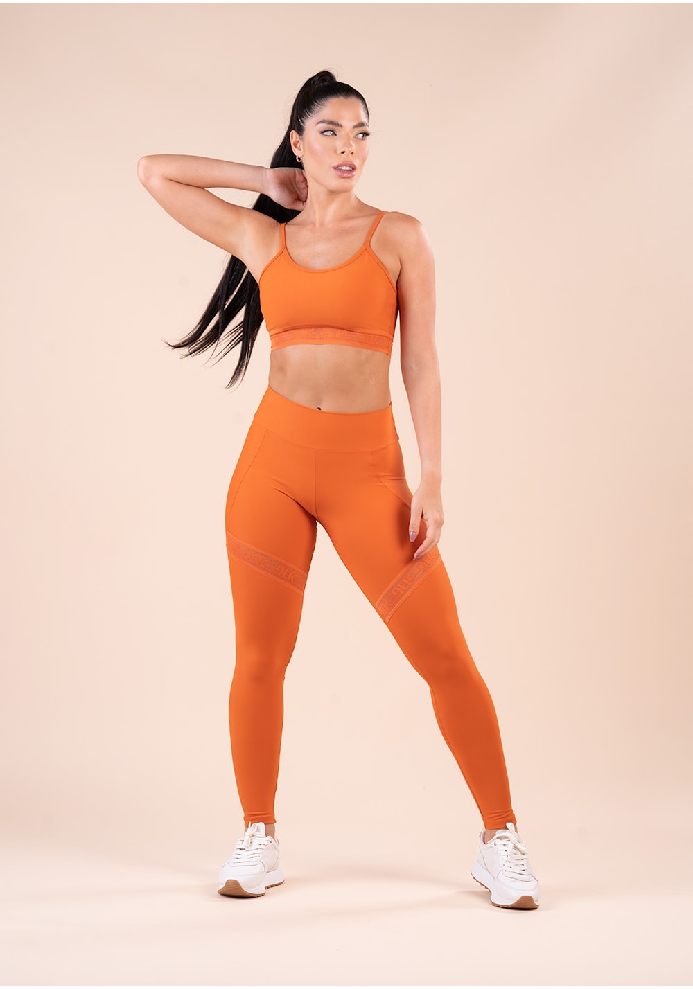 Legging fitness feminina laranja com recorte e elástico vazado action