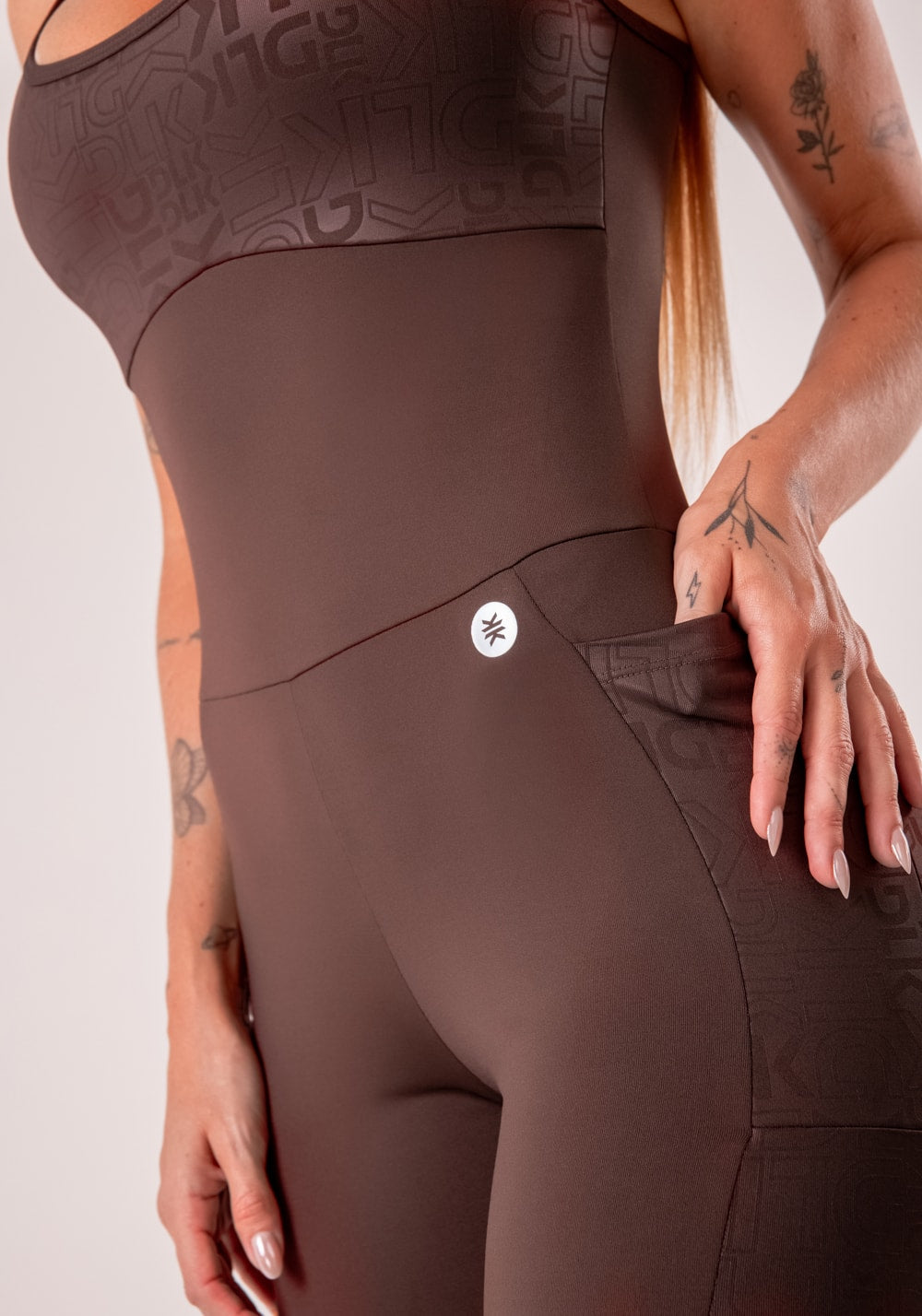 Macacão fitness feminino marrom com bojo e bolsos logomania reflections