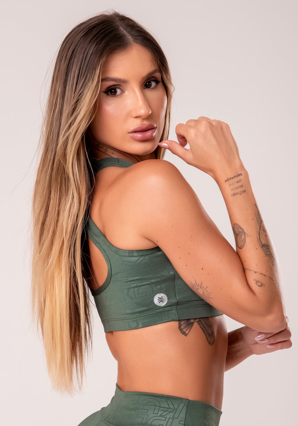 Top fitness feminino verde com bojo e recortes logomania reflections